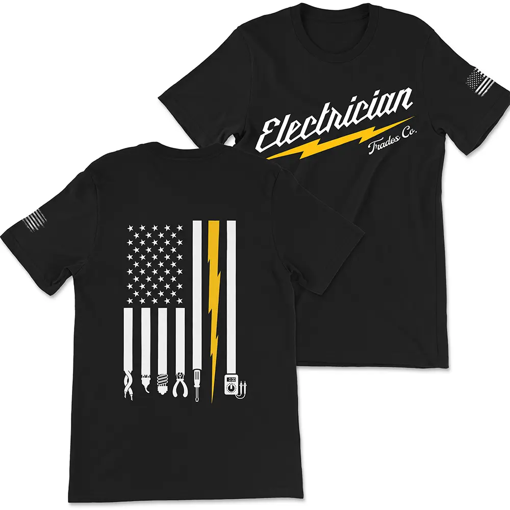 Black t-shirt with vertical American Flag in white, with one Yellow stripe shaped like a lightening bolt and electrician tools at the end of each white stripe. Front of the t-shirt says "Electrician" in white with yellow lightening bolt beneath it and "Trades Co". in script below that. Features worn white American flag on left sleeve.